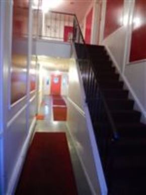Mentor-On-The-Lake apartment for rent - A staircase with a red carpet and a black railing.