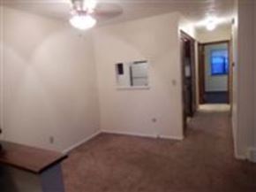 Mentor-On-The-Lake apartment for rent - A room with a brown carpet and a white wall.