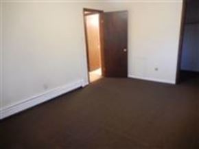 Mentor-On-The-Lake apartment for rent - A room with a brown door and white walls.
