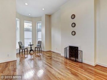 Baltimore house for rent - A living room with a fireplace and a table with chairs.