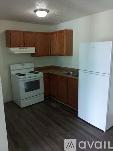 Frankfort apartment for rent - A small kitchen with a white fridge and a white stove.