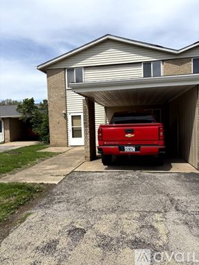 Pekin house for rent - A red truck is parked in a garage.