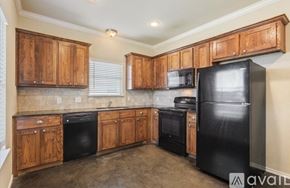 Waco house for rent - A bedroom with a bed, a table, and a ceiling fan.