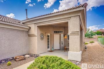 Marana house for rent - A living room with a brown leather couch and a wooden coffee table.