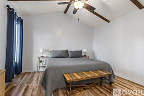 Sherwood house for rent - A bedroom with a bed, nightstands, and a ceiling fan.