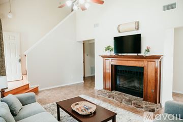 Sherwood house for rent - A living room with a fireplace and a television above it.