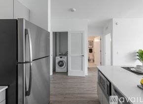 Chicago house for rent - A modern kitchen with a black refrigerator and a washing machine in the background.