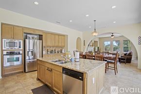 La Quinta house for rent - A kitchen with wooden cabinets and a granite countertop.