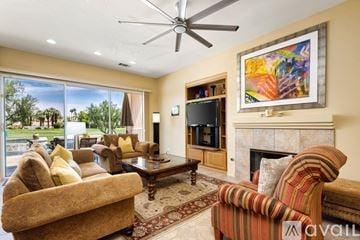La Quinta house for rent - A living room with a fireplace and a painting on the wall.