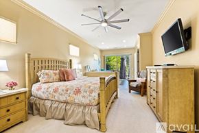 La Quinta house for rent - A bedroom with a large bed and a television mounted on the wall.
