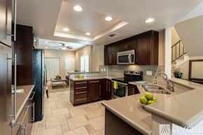 La Quinta house for rent - A kitchen with a refrigerator, microwave, oven, sink, and countertop.