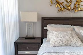 North Hollywood house for rent - A bedroom with a bed, nightstand with a lamp, and a wall decoration.