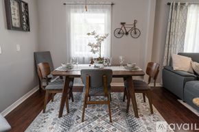 North Hollywood house for rent - A dining room with a table set for four and a bicycle on the wall.