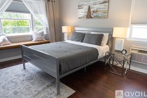 North Hollywood house for rent - A bedroom with a large bed and a painting on the wall.