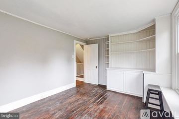West Chester house for rent - A kitchen with white cabinets and a blue counter.