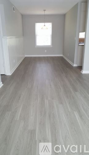 Hinesville apartment for rent - A room with a wooden floor and a window.