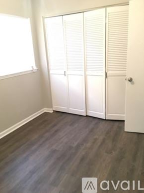 Hinesville apartment for rent - A room with a wooden floor and white walls.