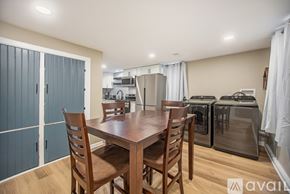 Grand Rapids house for rent - A kitchen with a table and chairs in the foreground and a refrigerator and oven in the background.