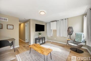Grand Rapids house for rent - A living room with a wooden coffee table and grey couch.