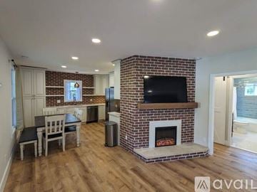 Asheville apartment for rent - A living room with a fireplace and a television on the wall.