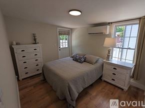 Asheville apartment for rent - A bedroom with a bed, dresser, and nightstand.