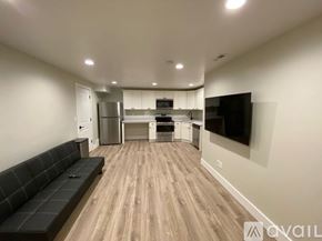 Lehi apartment for rent - A modern kitchen with a black bench and wooden flooring.