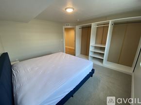 Lehi apartment for rent - A bedroom with a bed, shelves, and a closet.
