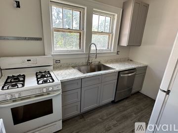 Bloomington apartment for rent - A kitchen with a white stove and a window.