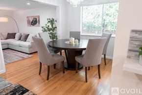 Fullerton house for rent - A modern dining room with a round table and grey chairs.