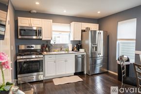 North Hollywood townhouse for rent - A kitchen with stainless steel appliances and white cabinets.
