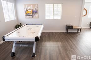 Cypress house for rent - A pool table in a room with a painting on the wall and a bench.