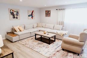 North Hollywood townhouse for rent - A living room with a white sofa, a coffee table, and two chairs.