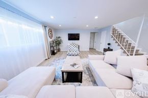 Los Angeles townhouse for rent - A living room with white furniture and a staircase.