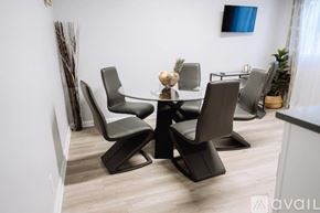 Los Angeles townhouse for rent - A modern dining room with a glass table and chairs.