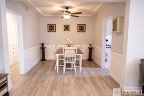 Los Angeles house for rent - A dining room with a wooden table and chairs.