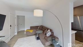 North Hollywood apartment for rent - A modern living room with a curved wall and a sectional sofa.