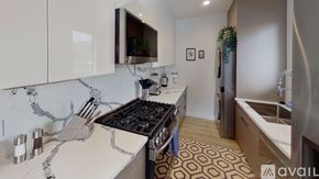 North Hollywood apartment for rent - A kitchen with a marble countertop and a stove top oven.