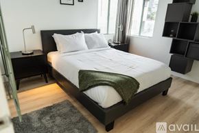 North Hollywood apartment for rent - A bedroom with a large bed and a green blanket.