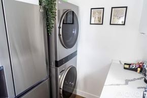 North Hollywood apartment for rent - A modern kitchen with a stainless steel refrigerator and a washing machine.