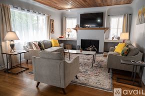 North Hollywood house for rent - A living room with a grey couch, a fireplace, and a television.