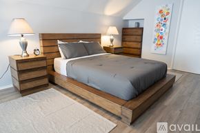 North Hollywood house for rent - A bedroom with a large bed and two nightstands with lamps.