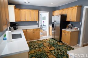 North Hollywood house for rent - A kitchen with wooden cabinets and a black refrigerator.