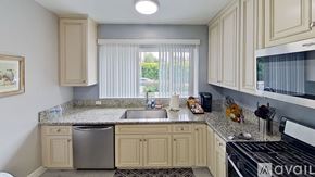 Los Angeles house for rent - A kitchen with beige cabinets and granite countertops.