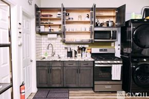 Los Angeles house for rent - A kitchen with a black oven and a white door.