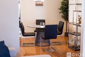 Los Angeles house for rent - A modern dining room with a glass table and chairs.