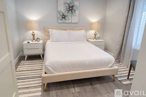 Glendale house for rent - A bedroom with a large bed and two nightstands with lamps.