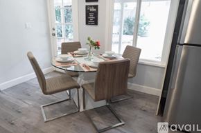 Glendale house for rent - A modern dining room with a glass table and chairs.
