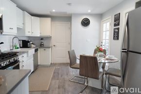 Glendale house for rent - A kitchen with a table and chairs in the middle of the room.