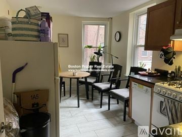 Boston apartment for rent - A kitchen with a table and chairs in the middle of the room.