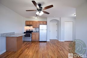 Chicago apartment for rent - A kitchen with wooden floors and a ceiling fan.